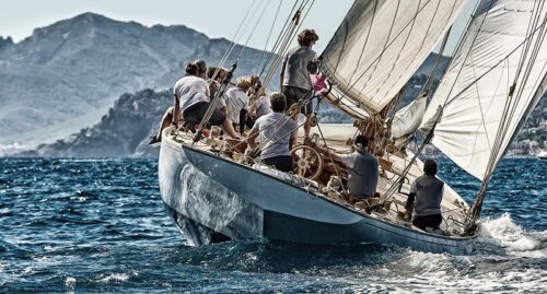 Sailing boat approaching coast line